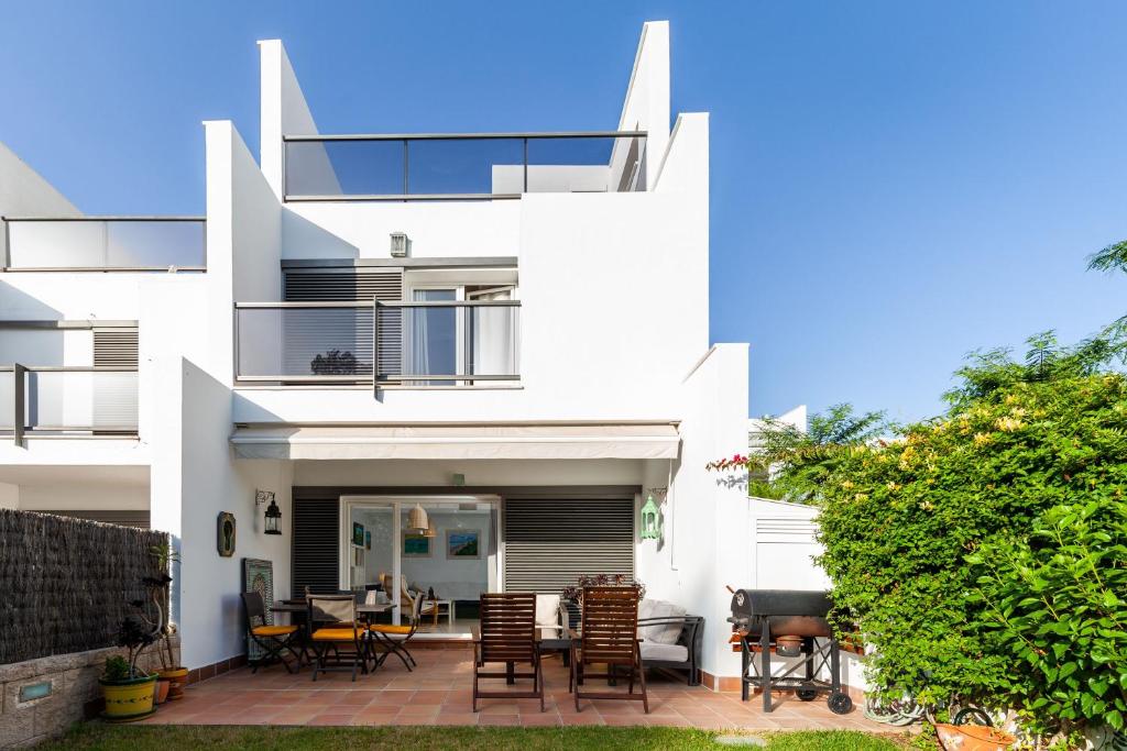 a white house with a patio in front of it at Casa la fontanilla Mila in Conil de la Frontera