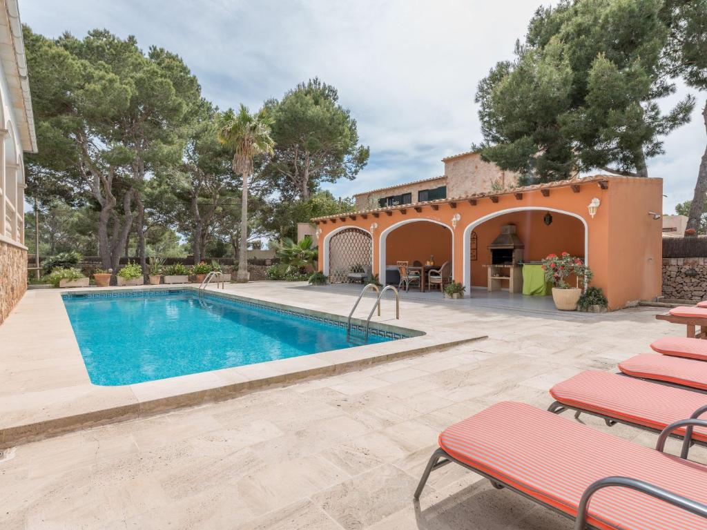 uma villa com uma piscina e uma casa em Villa Torre em Cala Santanyi