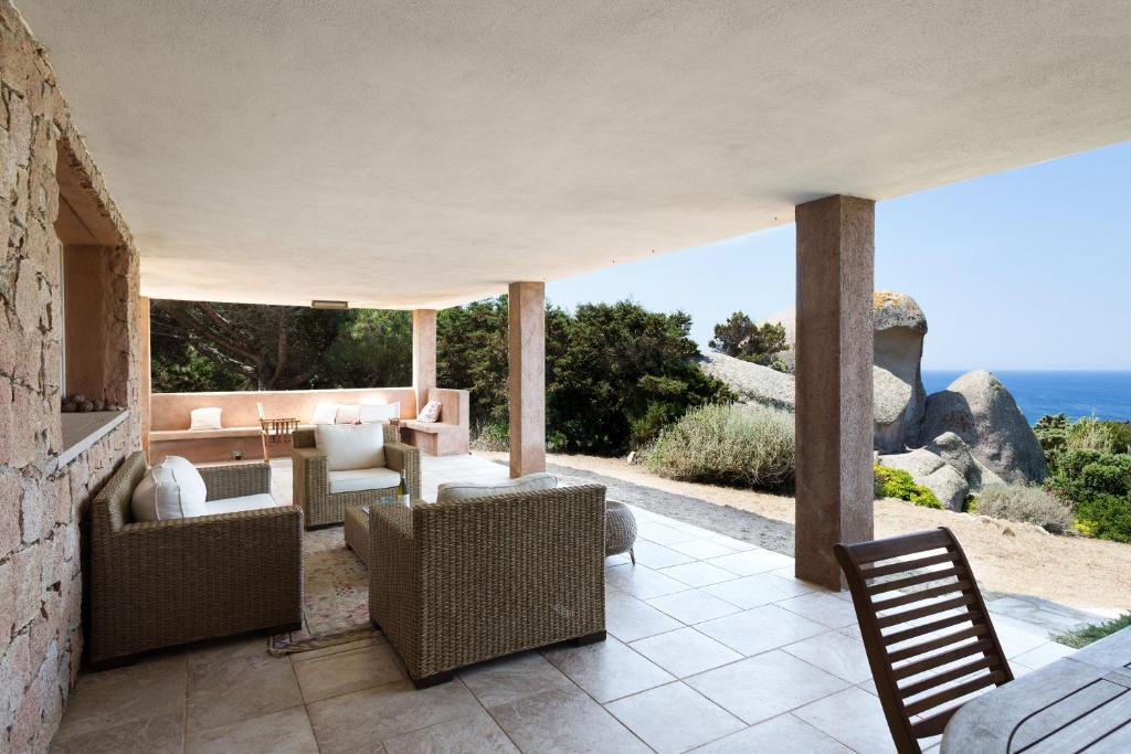 a patio with a view of the ocean at Villa I Graniti in Santa Teresa Gallura