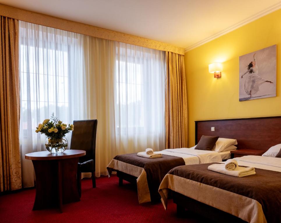 Postel nebo postele na pokoji v ubytování Hotel Piotr Spa&Wellness