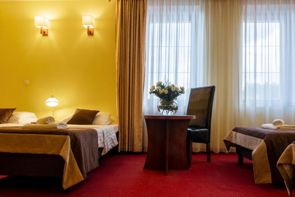 Postel nebo postele na pokoji v ubytování Hotel Piotr Spa&Wellness