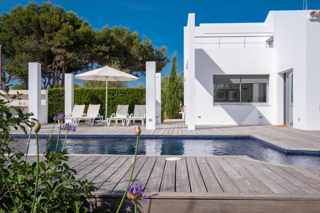 a villa with a swimming pool and a house at Villa Xipell 9 in Cala Santandria