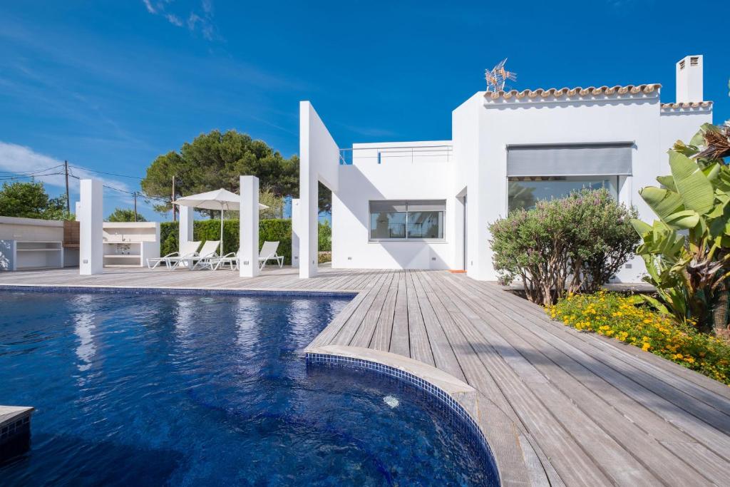 a villa with a swimming pool and a house at Villa Xipell 9 in Cala Santandria