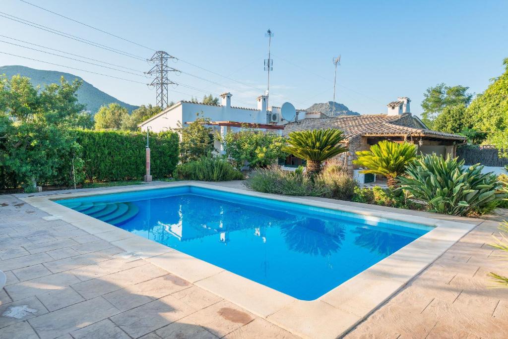 a swimming pool in the backyard of a house at Villa Can Tonet in Port de Pollensa