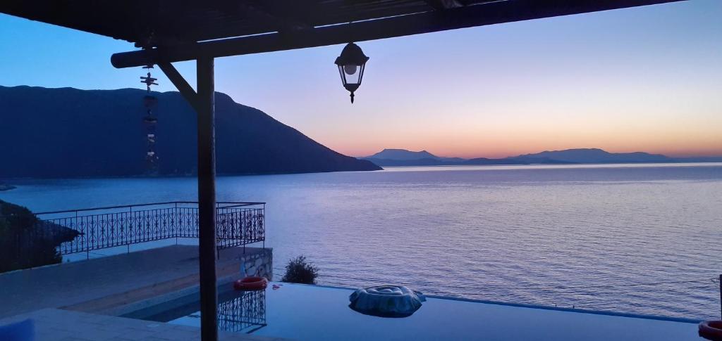 a view of a body of water at sunset at Villa LeSunLuka Lefkada in Vasiliki