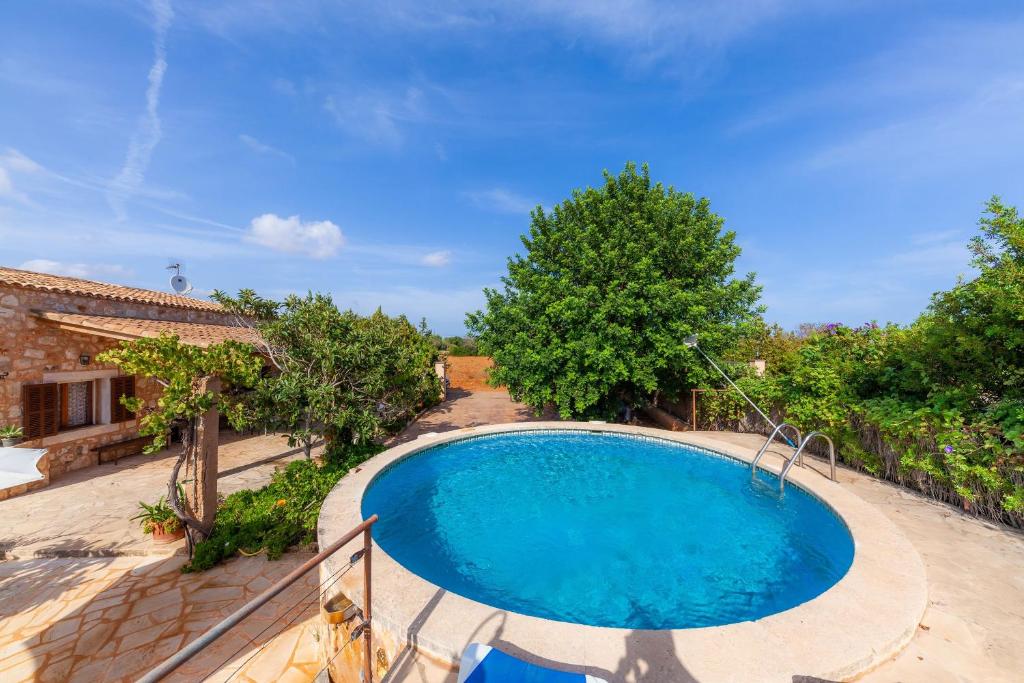 an image of a swimming pool in the backyard of a house at Villa Jacoba in Cala Mondrago