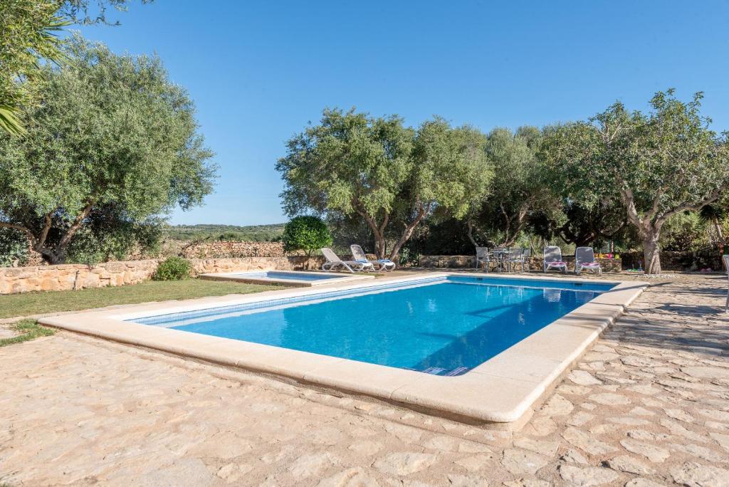 a swimming pool in a yard with trees at Es Rafal Roig - Es Verd in Sant Llorenç des Cardassar