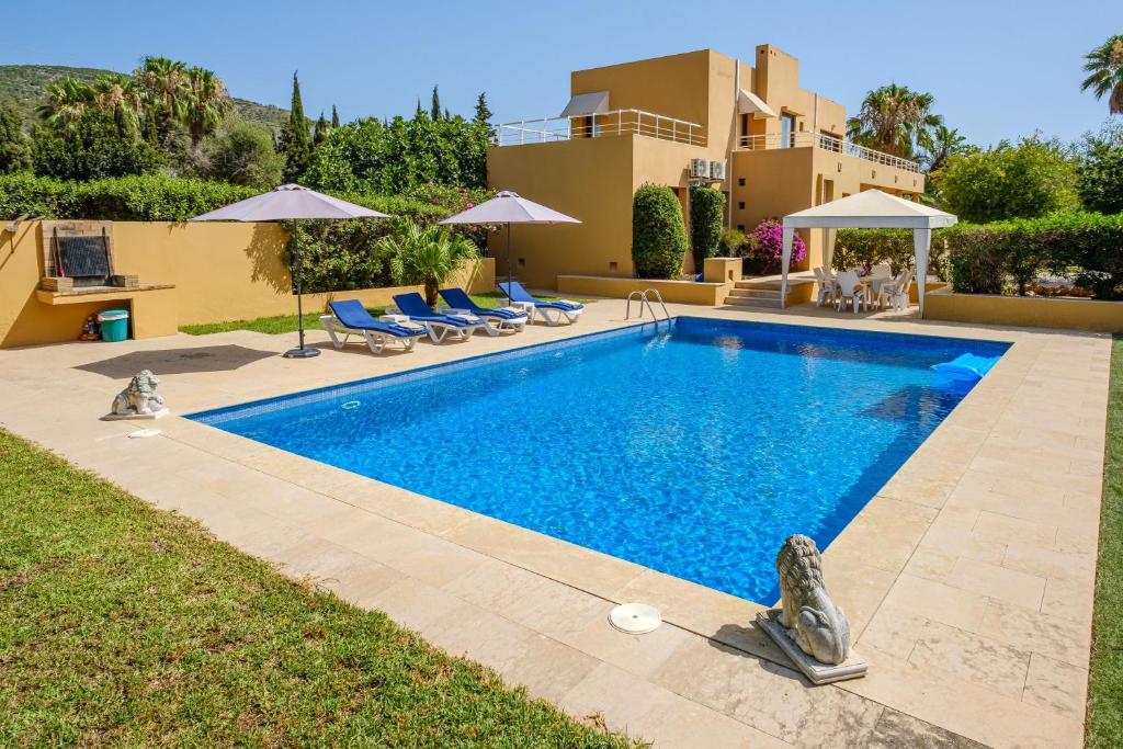 a swimming pool in front of a villa at Villa Sunrise in Sant Josep de Sa Talaia