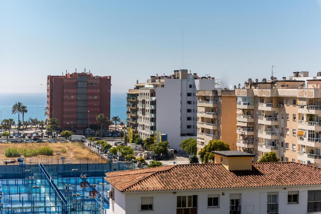 uma vista para uma cidade com edifícios e o oceano em Apartamento Mariam em Málaga