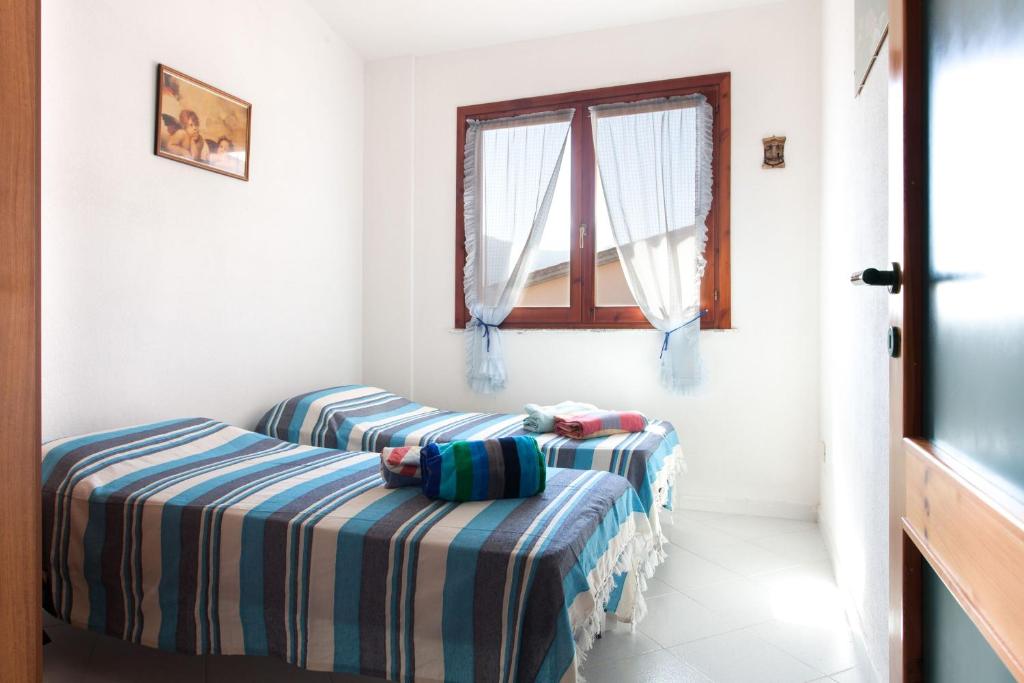 Łóżko lub łóżka w pokoju w obiekcie Villa Rita