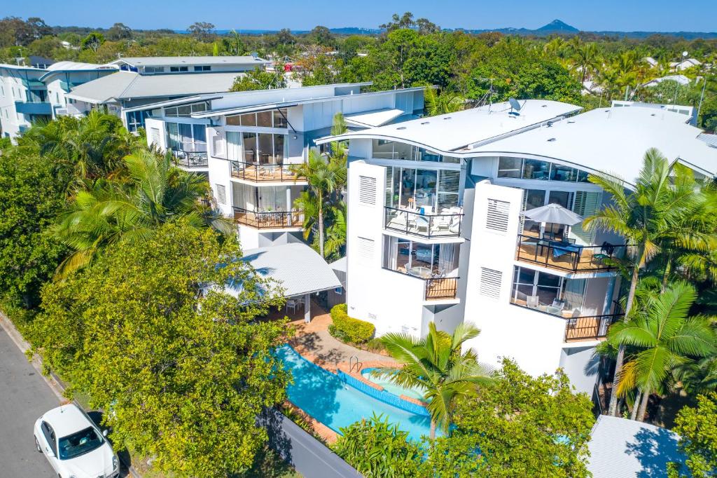 an aerial view of a building with a pool and trees at Twin Quays Noosa in Noosaville
