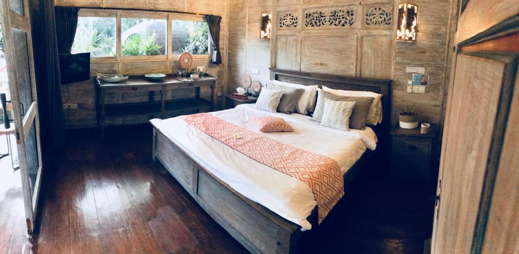 Säng eller sängar i ett rum på Villa Bali Santai