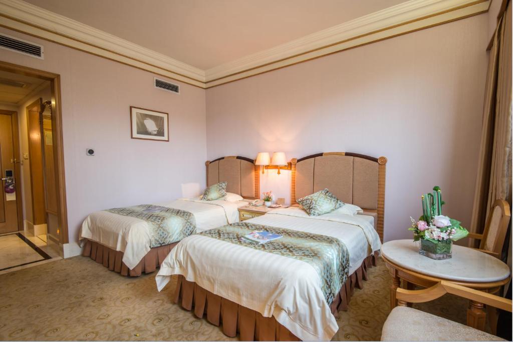 Postel nebo postele na pokoji v ubytování Panyu Hotel