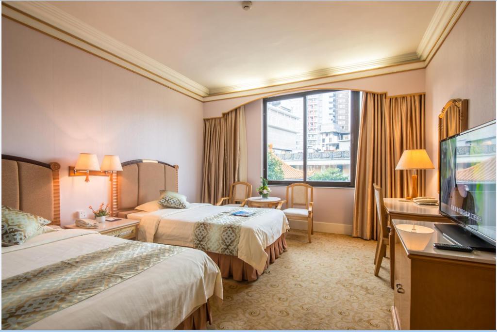 Postel nebo postele na pokoji v ubytování Panyu Hotel