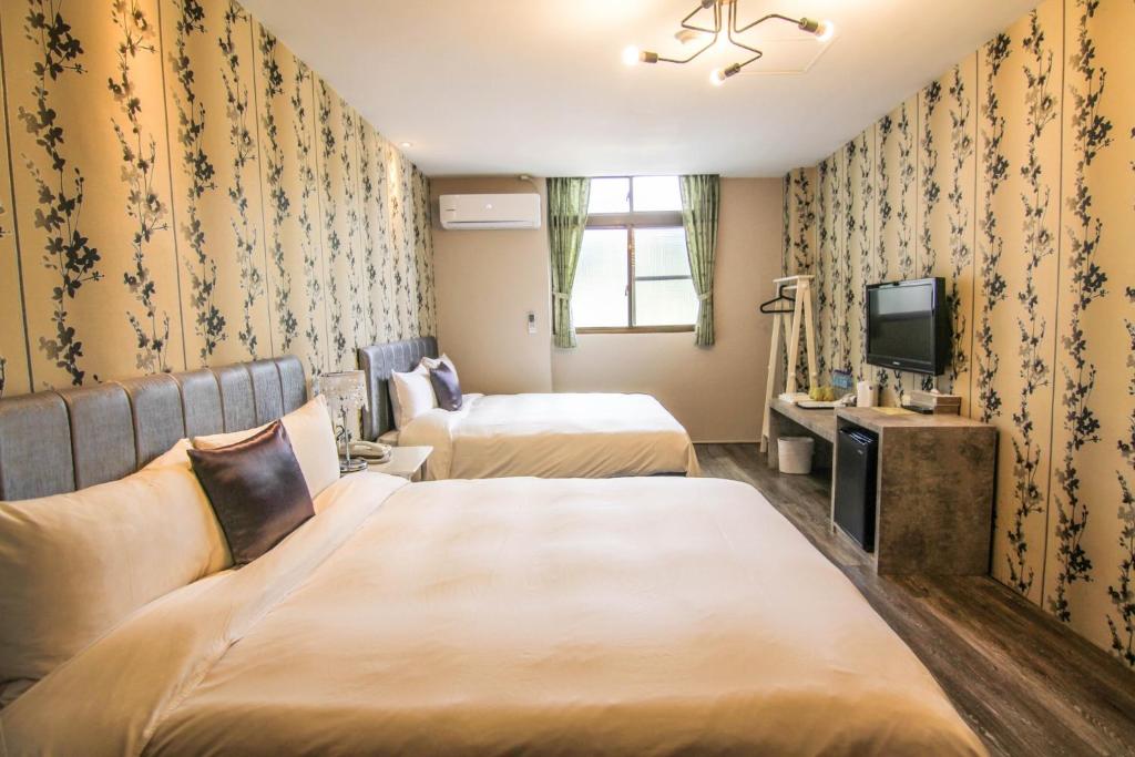 Postel nebo postele na pokoji v ubytování Sun Moon Lake Loft Inn