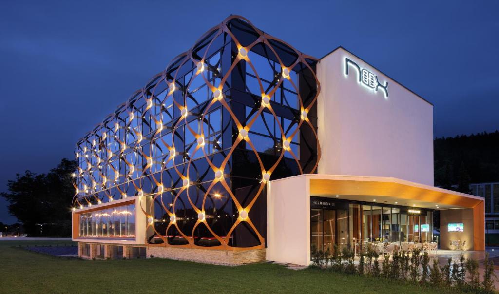 a building with a lit up facade at night at Hotel Nox in Ljubljana