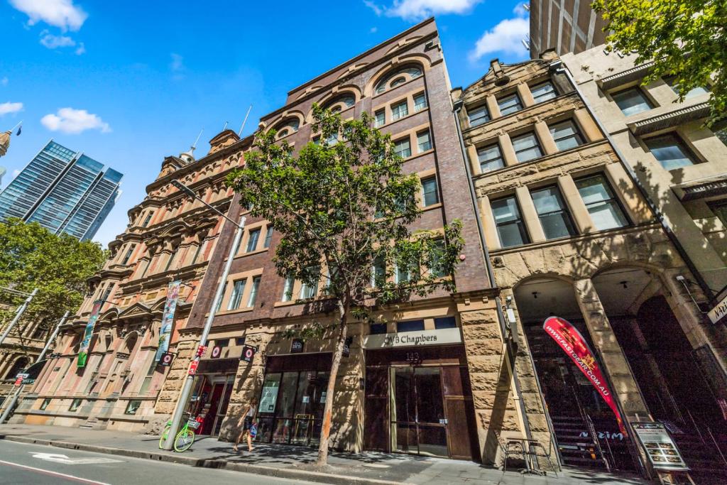 an old building on the corner of a street at YEHS Hotel Sydney QVB in Sydney