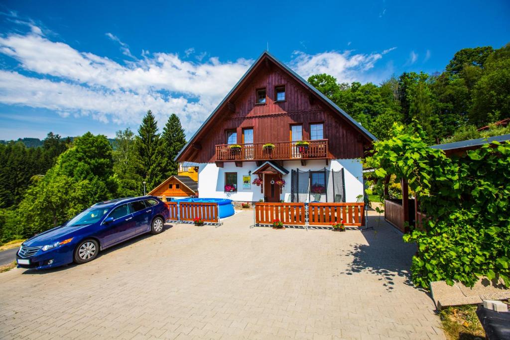 un coche azul estacionado frente a una casa en Apartment Nedrik en Rokytnice nad Jizerou