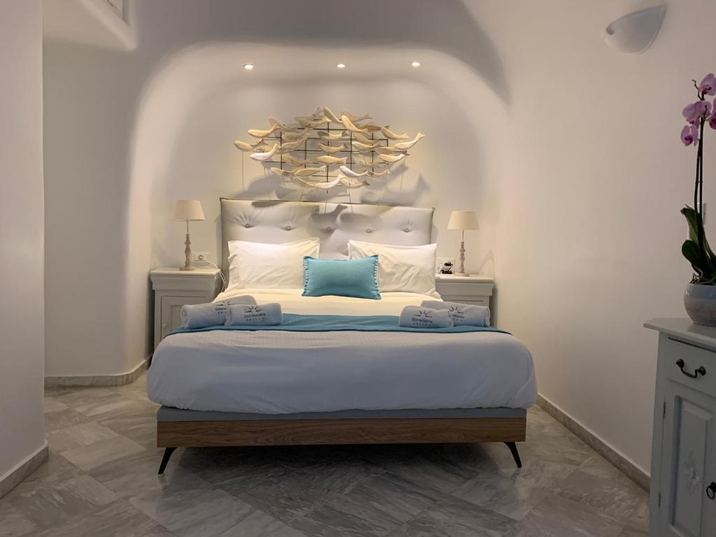 A bed or beds in a room at Iliovasilema Suites