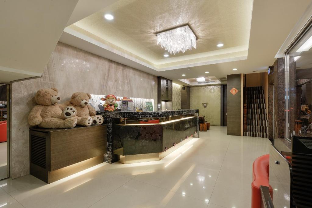 a lobby with teddy bears sitting on a counter at Happy Hotel in Kaohsiung