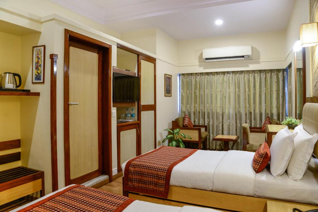 Postel nebo postele na pokoji v ubytování Hotel Ameya