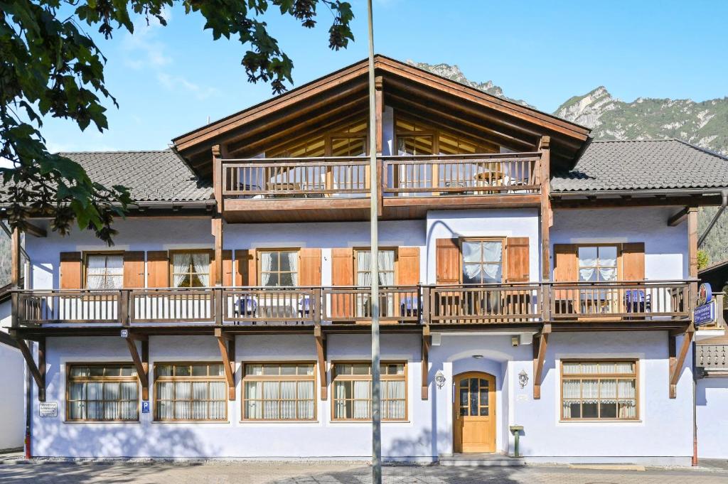 an apartment building with balconies and a deck at Katharinenhof Wohnung Kramer (2) in Garmisch-Partenkirchen
