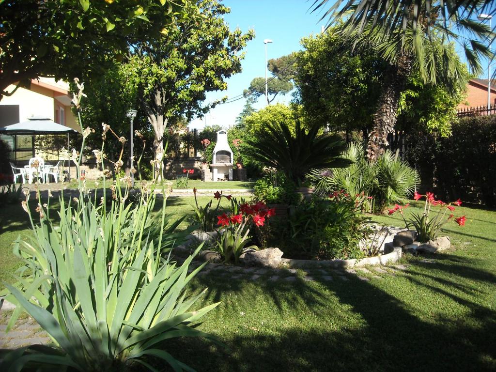 a garden with plants and flowers in a yard at Giardino Degli Aranci B&B in Ponte Galeria