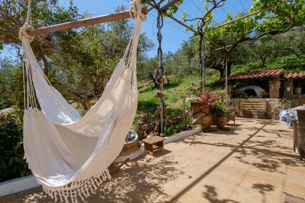 a hammock in a yard with a garden at Traditional Family Cretan Home! in Yerakianá