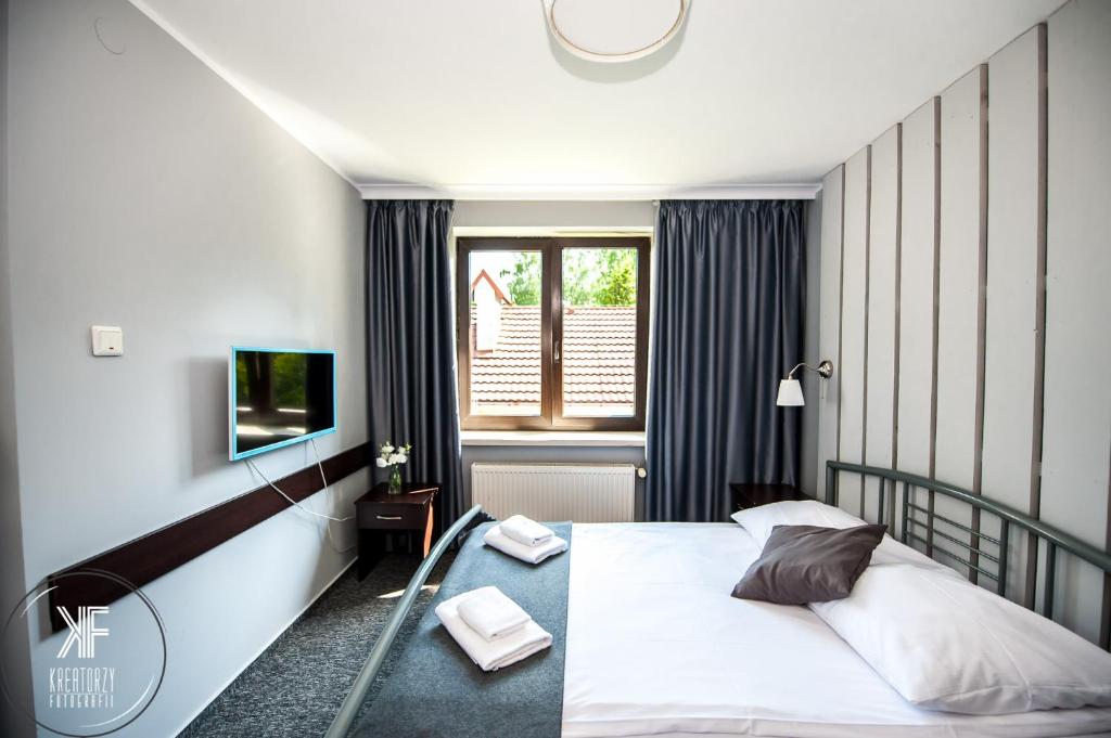 Posteľ alebo postele v izbe v ubytovaní Hotel Otomin