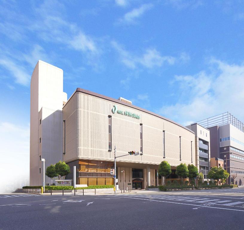 a large white building with a street in front of it at Hotel Awina Osaka in Osaka