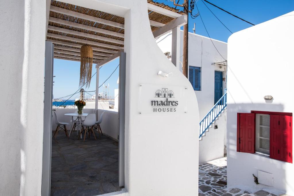 a white toilet sitting next to a white door at Madres Houses in Mikonos