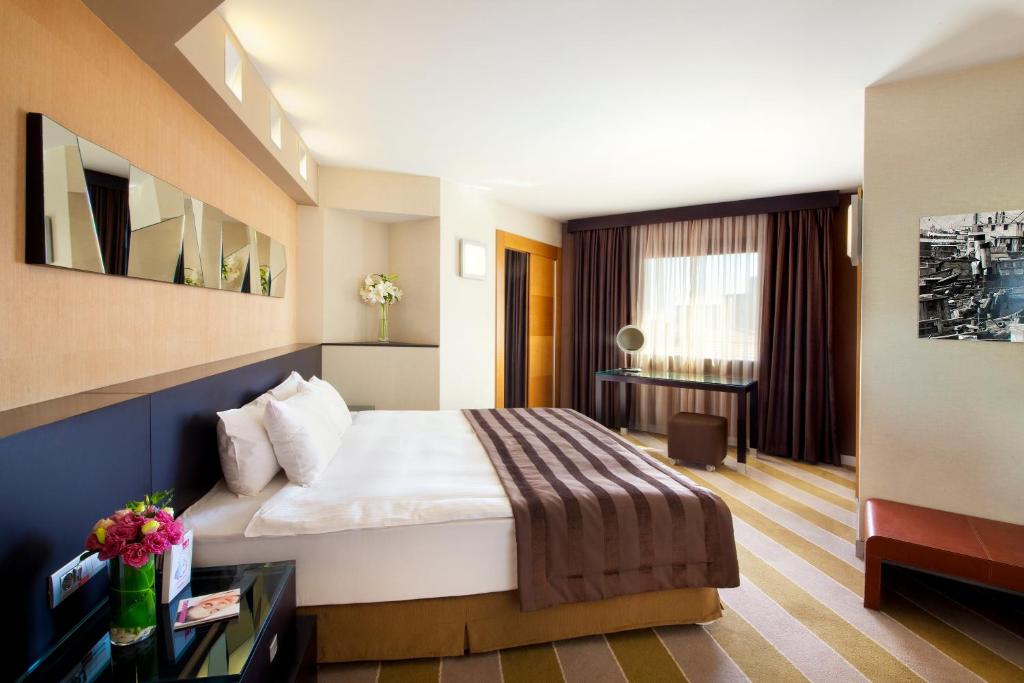a hotel room with a bed and a television at Point Hotel Taksim in Istanbul