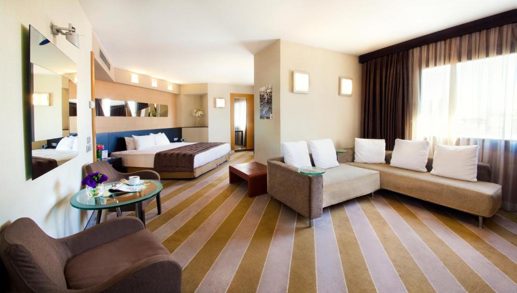 a large living room with a couch and a bed at Point Hotel Taksim in Istanbul