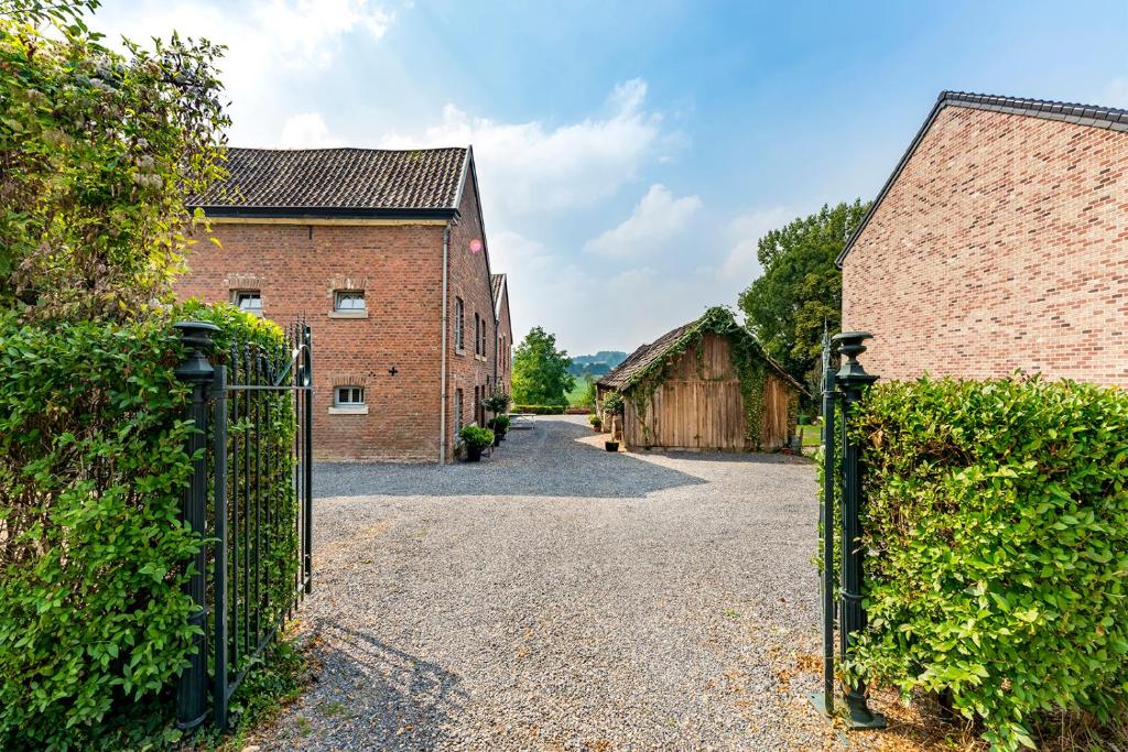 an entrance to a barn with a metal gate at De Appelgaard in Sint-Martens-Voeren