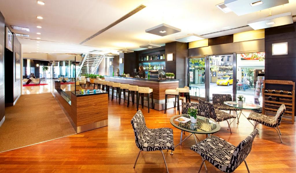 a lobby with chairs and tables and a bar at Point Hotel Taksim in Istanbul