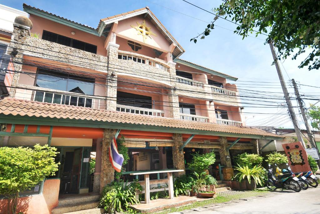 a building with a balcony on top of it at Casa Brazil Homestay in Karon Beach