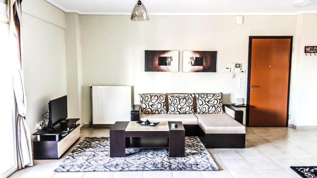 a living room with a couch and a coffee table at Comfort Luxury Maisonette in Thessaloniki