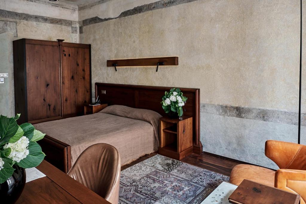 a bedroom with a bed and a table at Hotel Stary in Kraków