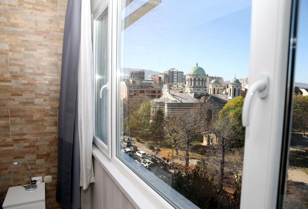 a window with a view of a city at COLORED HOUSE Apartments in Sofia