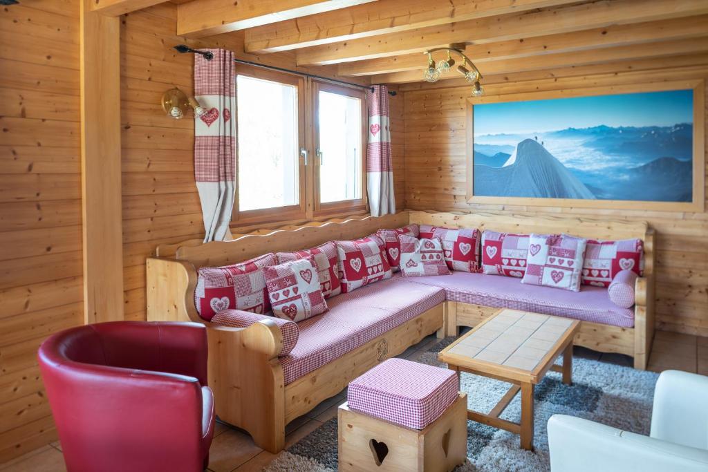 a room with a bench in a wooden house at Chalet Le Lapye in Les Gets