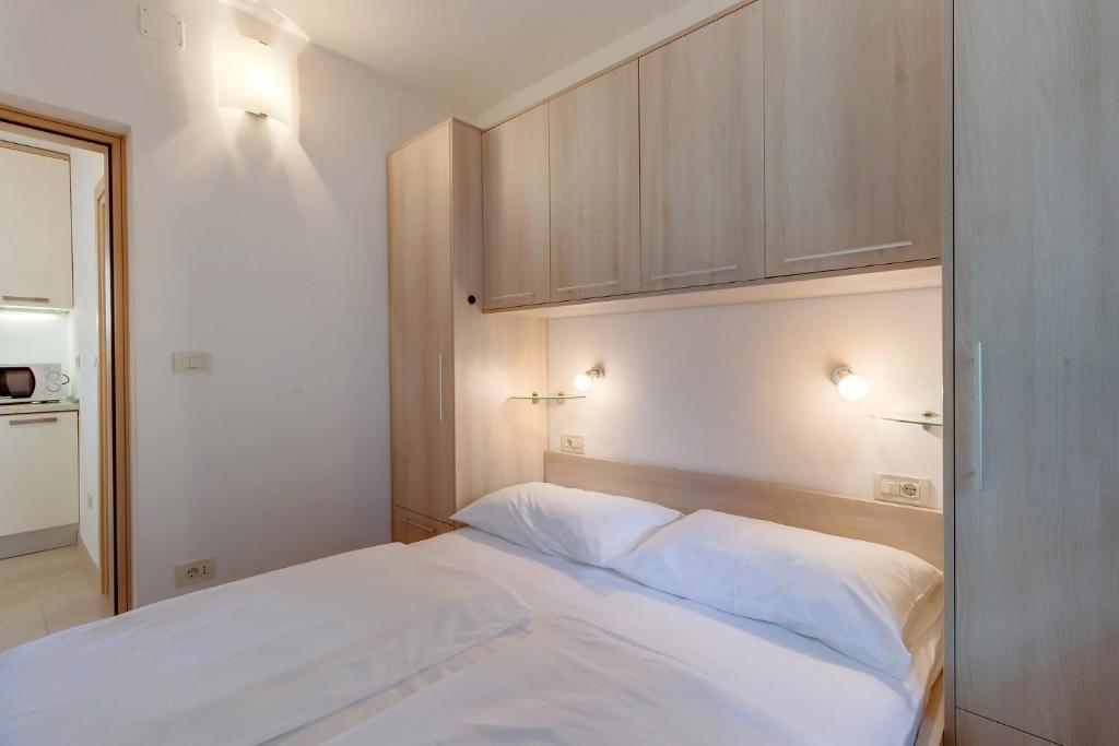 Postel nebo postele na pokoji v ubytování Apartments Pineta