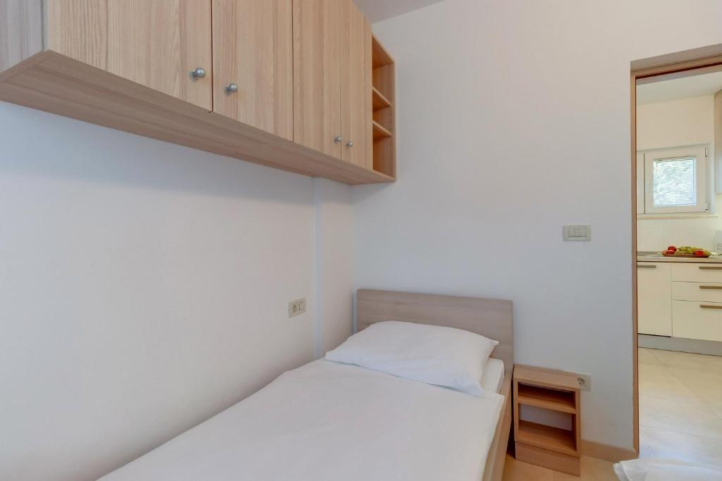 Postel nebo postele na pokoji v ubytování Apartments Pineta