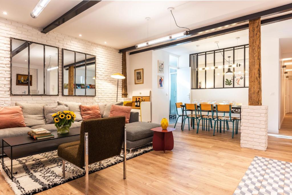 a living room with a couch and a table at Design & New Loft in heart of Paris in Paris