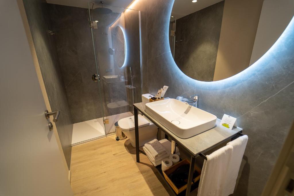 a bathroom with a sink and a mirror at Hotel Taburiente S.C.Tenerife in Santa Cruz de Tenerife