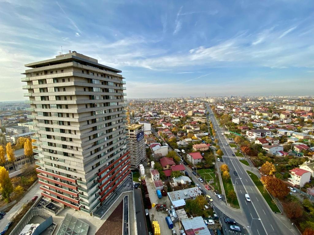 an overhead view of a city with a tall building at Monaco Grand Apartments By CityBookings in Bucharest