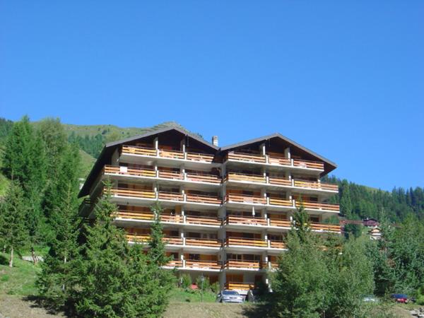 a large building with trees in front of it at Lona C 43 in Grimentz