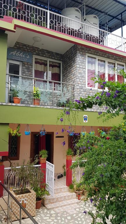 a building with a bunch of potted plants on it at Abhi's homestay in Port Blair