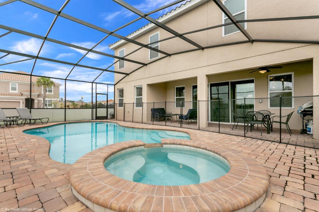 a swimming pool in a patio with a glass ceiling at Veranda Palms 8 Bedroom Home with Pool - 1722 in Kissimmee