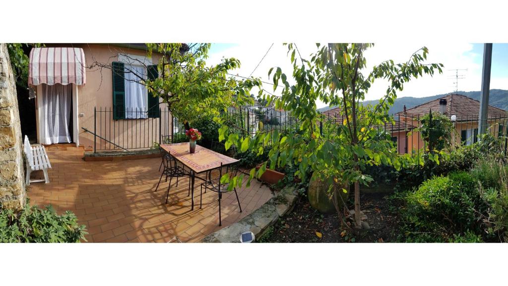 a small patio with a table in front of a house at Casa Dalia in Pietrabruna