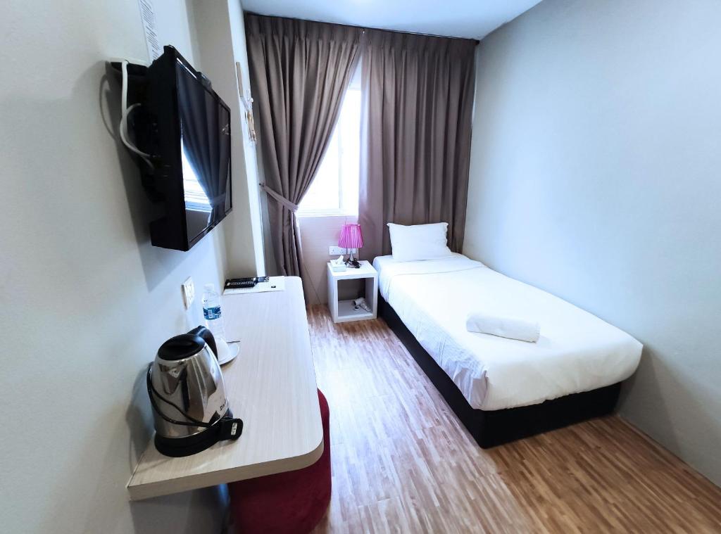 Postel nebo postele na pokoji v ubytování Princess Hotel Pontian